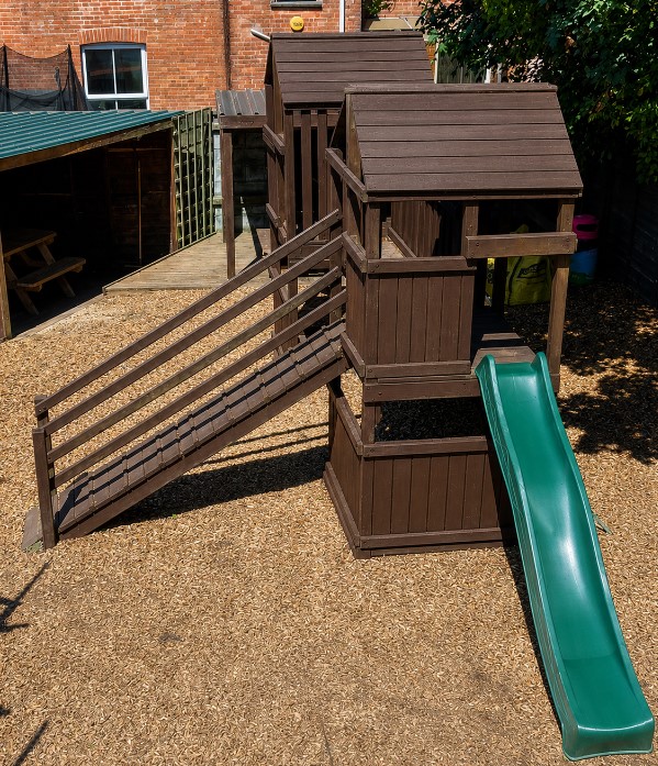 Children's wooden play area and slide in the beer garden at The Quintrell Inn near Newquay, Cornwall.