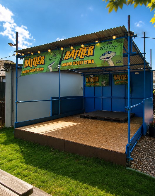Outdoor live music stage in the beer garden at The Quintrell Inn in Quintrell Downs near Newquay, Cornwall.
